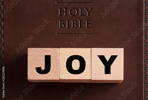 фотографія Joy Spelled in Blocks on a Leather Holy Bible
