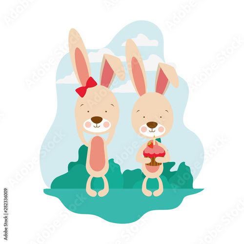 Fototapeta Naklejka Na Ścianę i Meble -  couple of bunnies with cake in hand