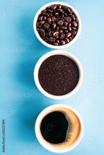 cup of coffee with beans on blue background