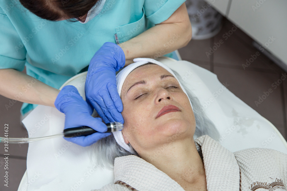 Portrait of middle aged woman having face treatment at beauty clinic Portrait of middle aged woman having face treatment at beauty clinic