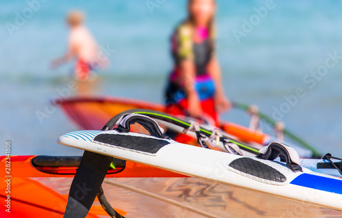surf gear detail with blurred female and sea in the background