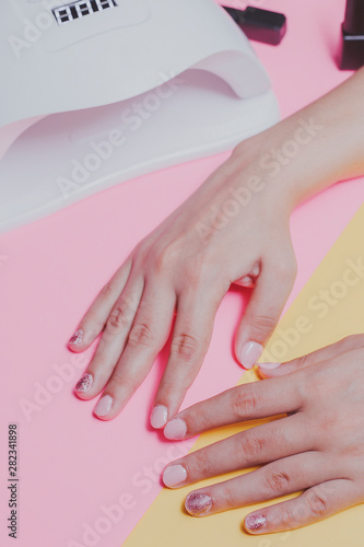 Female's hands after manicure procedure. Concept of nail polish art or shellac