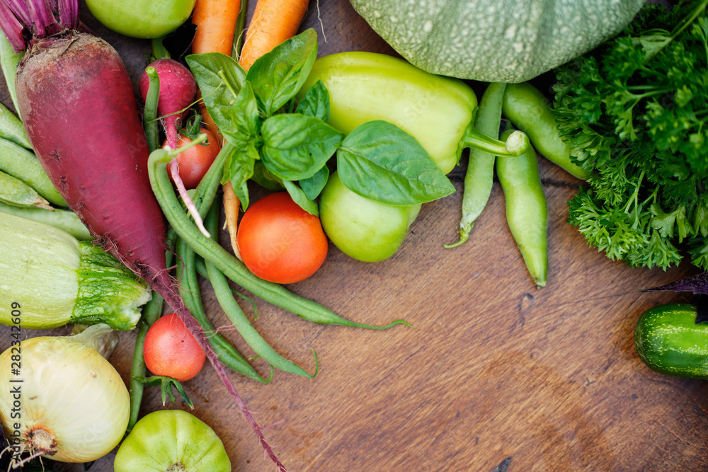 Fresh Harvest from the Gardens on Wooden chalkboard from above. Carrot, tomato, pepper, cucumber, onion, zucchini, radish, parsley. Fresh Harvest from the Gardens on Wooden chalkboard from above. Carrot, tomato, pepper, cucumber, onion, zucchini, radish, parsley.