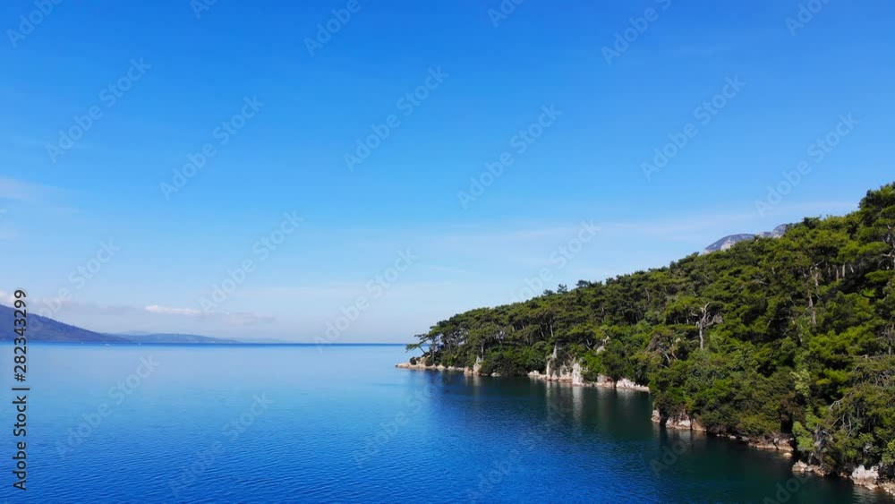 A scenic aerial view of the Aegean Sea and the Gulf of Gokova coastline on a bright summer day. A scenic aerial view of the Aegean Sea and the Gulf of Gokova coastline on a bright summer day.