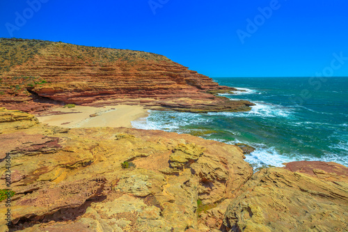 Scenic aerial view of Pot Alley in Kalbarri National Park, Western Australia from Pot Alley lookout. Rugged sandstone, Coral coast in turquoise Indian Ocean. Blue sky with copy space.