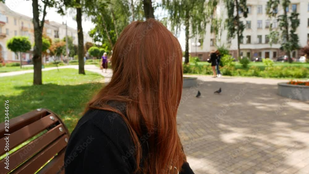 Red-haired girl in the park Red-haired girl in the park