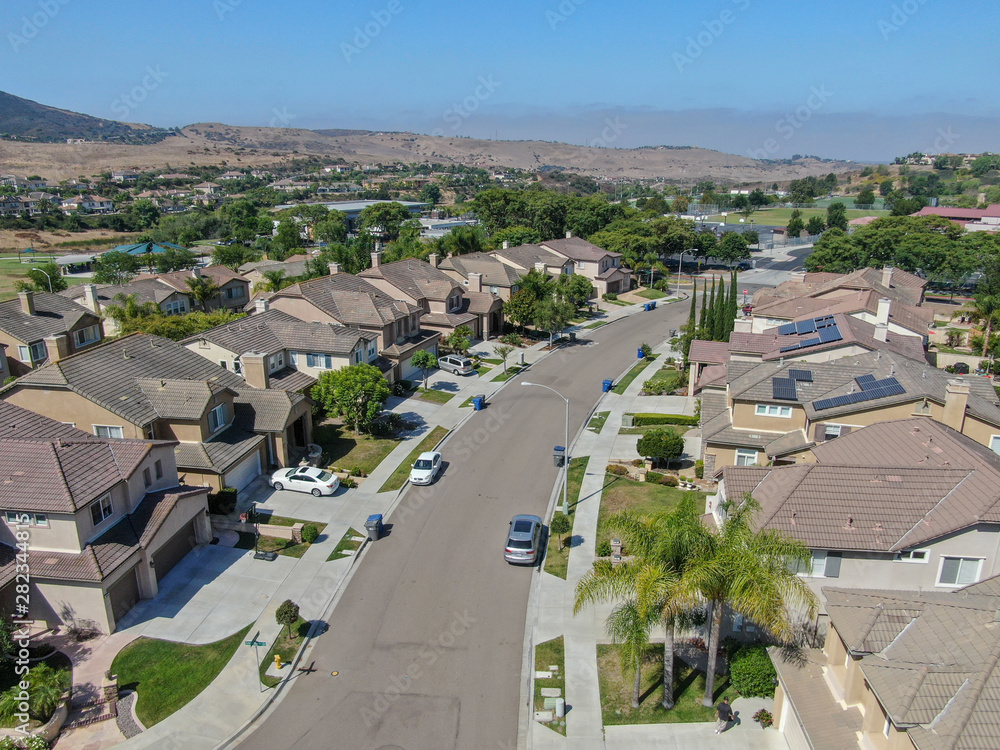 Suburban neighborhood street with big villas next to each other in Black Mountain, San Diego, California, USA. Aerial view of residential modern subdivision luxury house.