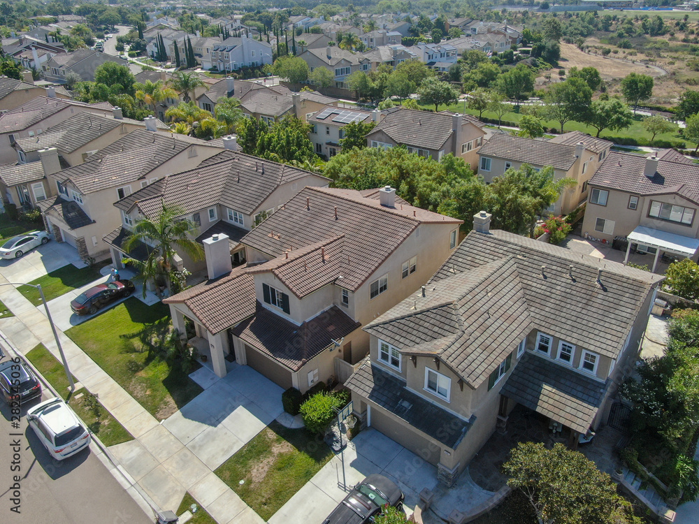 Suburban neighborhood street with big villas next to each other in