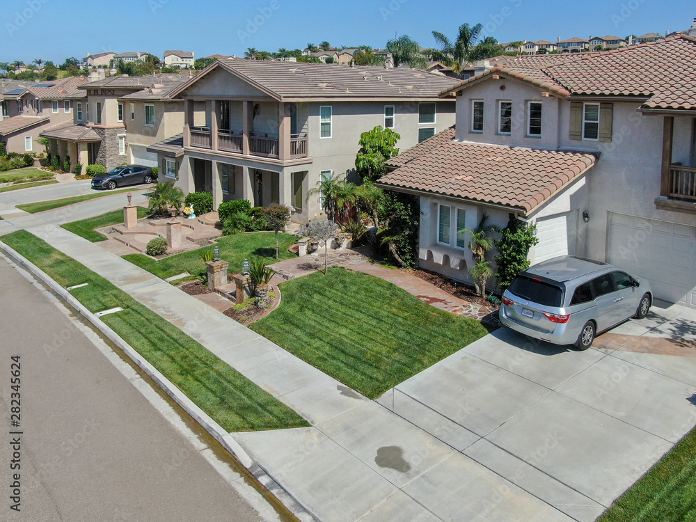 Suburban neighborhood street with big villas next to each other in