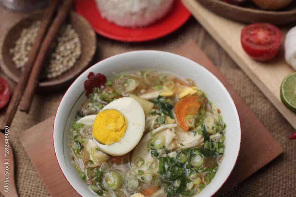 Indonesian chicken soto or soto ayam, served with white rice Indonesian chicken soto or soto ayam, served with white rice
