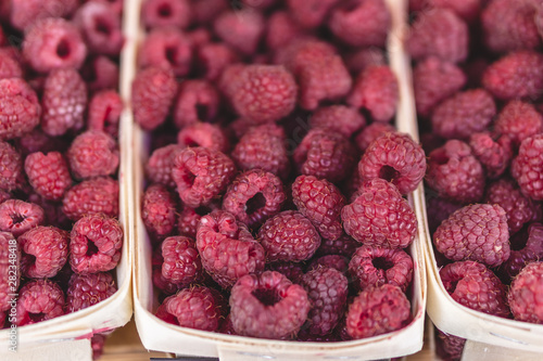 Raspberries on a farm market in the city. Selective focus.