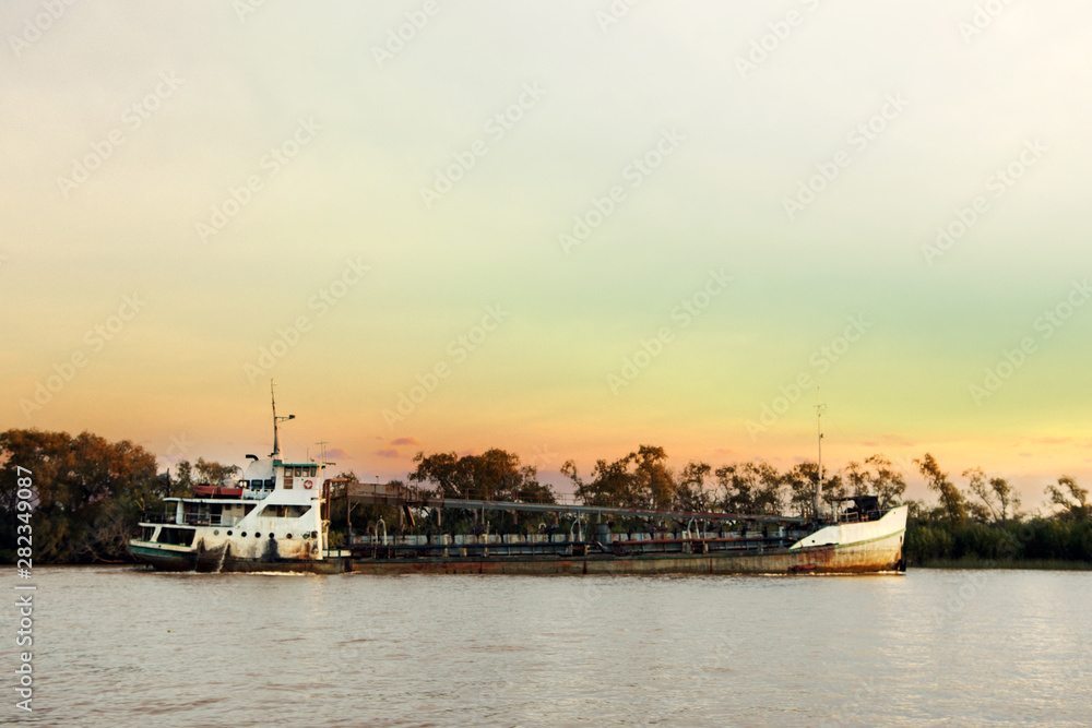 Sand extractor Ship sailing on the Parana River at Sunset,