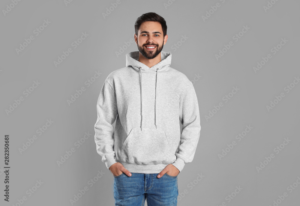 Portrait of young man in sweater on grey background. Mock up for design - obrazy, fototapety, plakaty 