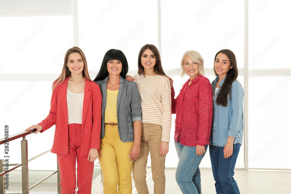 Fototapeta premium Group of ladies near window indoors. Women power concept