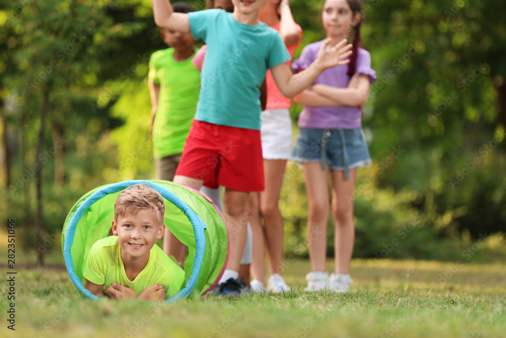 Fototapeta premium Cute little child playing with friends in park, space for text