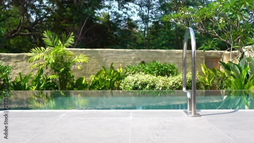 Wallpaper Mural Edge of a small private pool with ladder in a resort. Detail with vegetation Torontodigital.ca