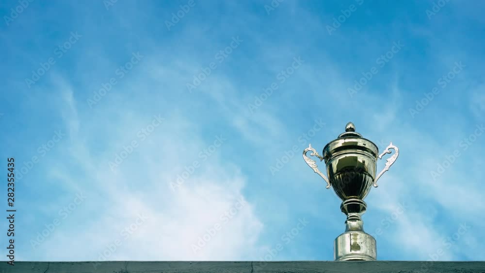 winner trophy on sky background - time lapse