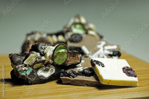 Black and White filled Chocolate pieces with coconut and raisins in a front angle