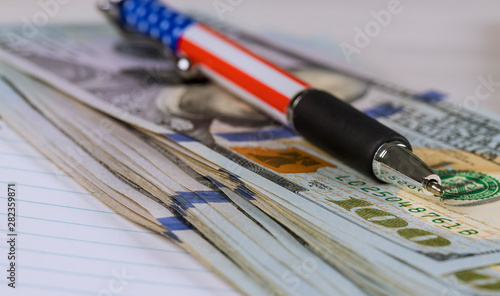 Fototapeta Naklejka Na Ścianę i Meble -  Pen and dollars on white table, close-up