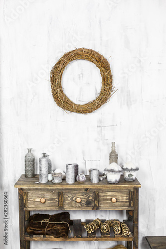 Ascetic scandinavian interior decorated for New Year Holidays. Wooden chest and commode near the Christmas tree