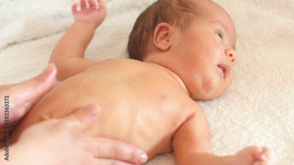 Mom does massage using oil to the baby. Caring for the newborn. Mom does massage using oil to the baby. Caring for the newborn.