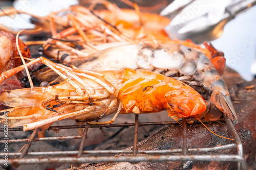 close up of many prawn on grille and charcoal