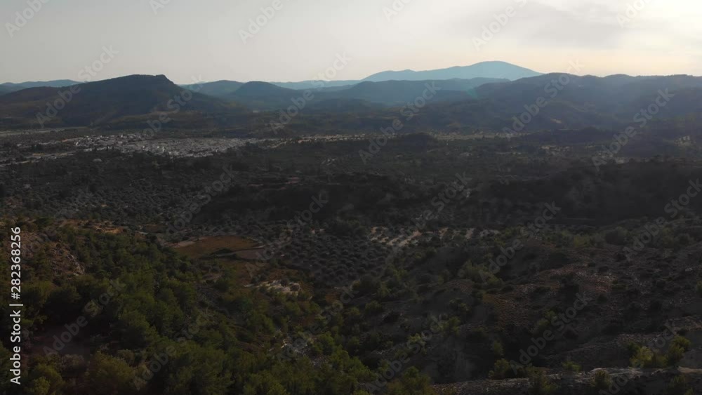 AERIAL: Countryside of rhodes island in the shadows of evening, greece AERIAL: Countryside of rhodes island in the shadows of evening, greece
