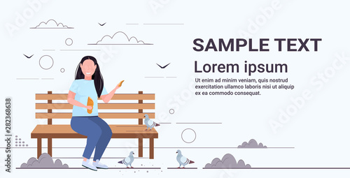 fat obese woman holding bread and feeding flock of pigeon overweight girl sitting wooden bench having fun outdoor public park flat full length horizontal copy space
