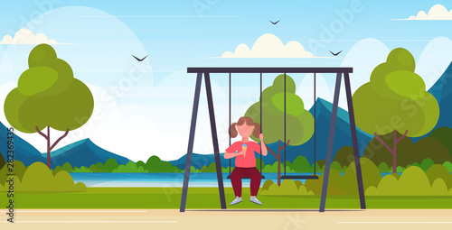 fat obese girl sitting on swing eating ice cream unhealthy nutrition obesity concept female overweight child swinging having fun outdoor summer park landscape flat full length horizontal