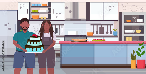 fat obese coupe holding big chocolate homemade cake sweet delicious overweight man woman celebrating holiday unhealthy nutrition obesity concept modern kitchen interior portrait horizontal