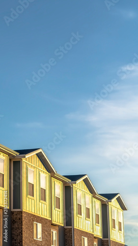 Vertical frame Townhomes with combination of wood brick and concrete wall on a sunny day