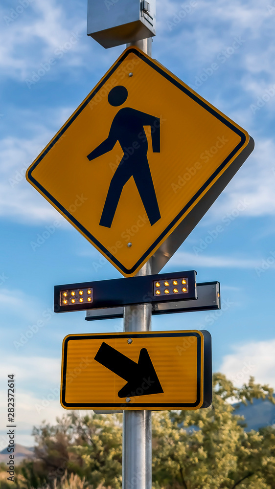Vertical frame Pedestrian Crossing Sign and Diagonal Arrow Right Sign with flashing lights Vertical frame Pedestrian Crossing Sign and Diagonal Arrow Right Sign with flashing lights