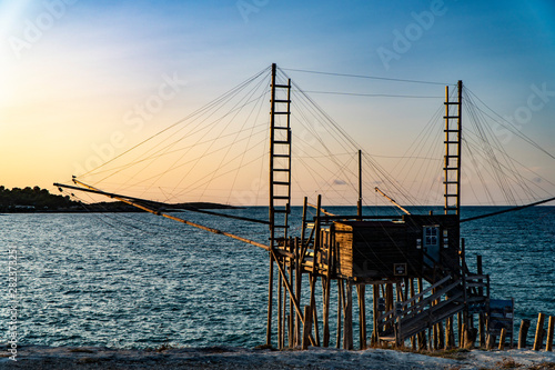 Beautiful seascape with a view of a trabucco at sunset in Italy