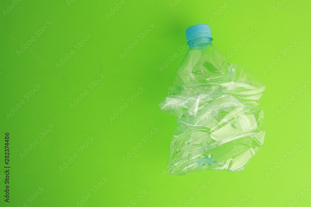 Empty plastic water bottle scaled for recycling