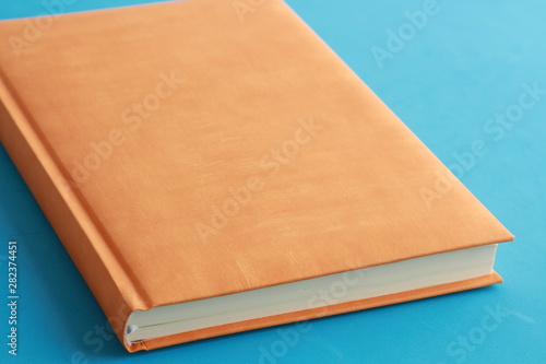 book with orange cover on colorful background