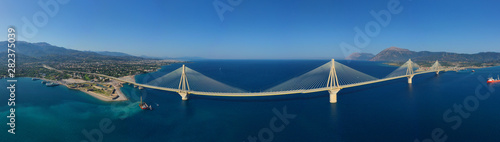 Aerial drone panoramic photo of world famous cable suspension bridge of Rio - Antirio Harilaos Trikoupis, crossing Corinthian Gulf, mainland Greece to Peloponnese, Patras