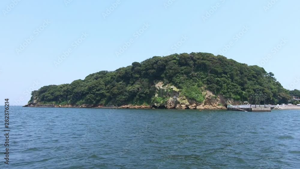 Sunny weather, approaching a small island Sunny weather, approaching a small island