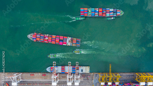 Aerial view cargo ship terminal, Unloading crane of cargo ship terminal, Aerial view industrial port with containers and container ship.