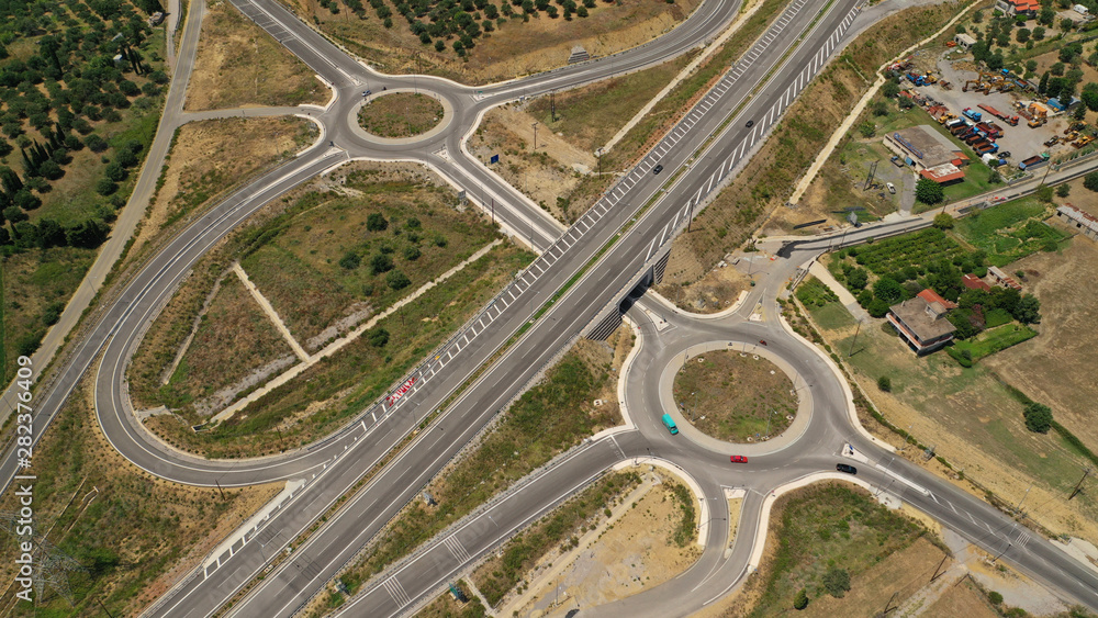 Aerial drone top view photo of modern roundabout as seen in low traffic motorway outside city centre Aerial drone top view photo of modern roundabout as seen in low traffic motorway outside city centre