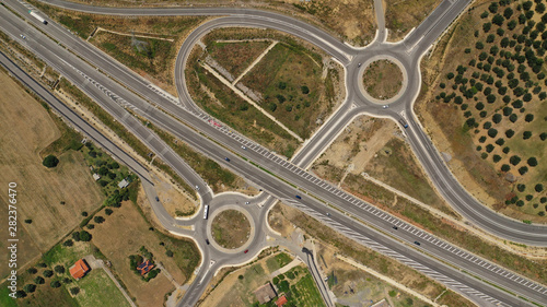 Aerial drone top view photo of modern roundabout as seen in low traffic motorway outside city centre