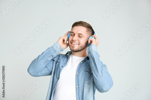 Handsome young man listenin...
