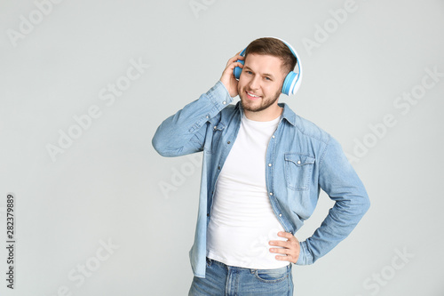 Handsome young man listenin...