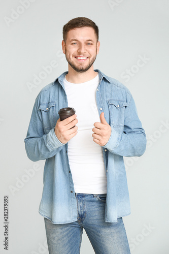 Handsome young man with cup...