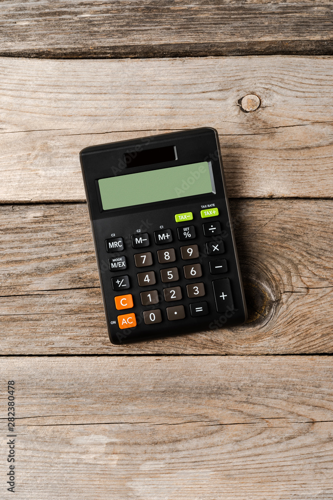 Calculator on wooden background. Top view Calculator on wooden background. Top view