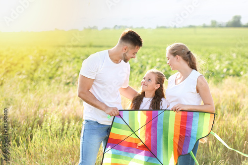 Happy family with kite in f...