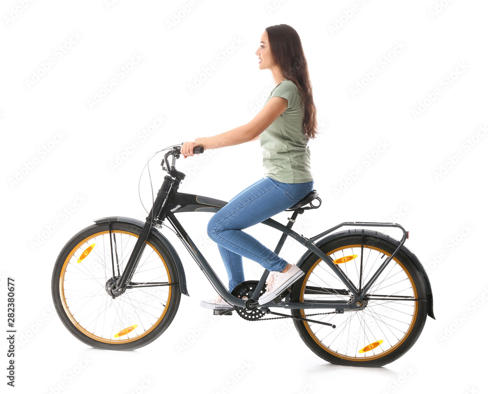 Beautiful young woman riding bicycle against white background Beautiful young woman riding bicycle against white background