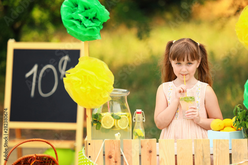 Cute little girl selling le...