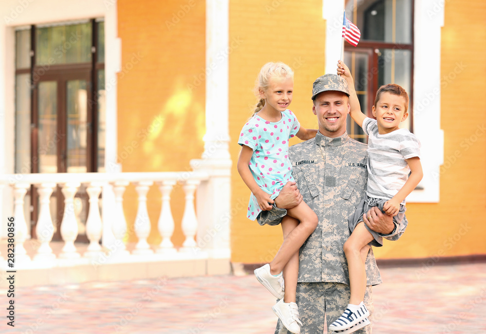 Happy military man with his children outdoors