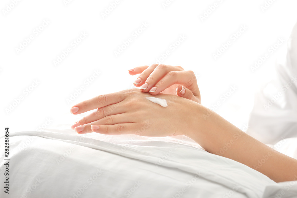 Young woman applying natural cream onto skin at home Young woman applying natural cream onto skin at home