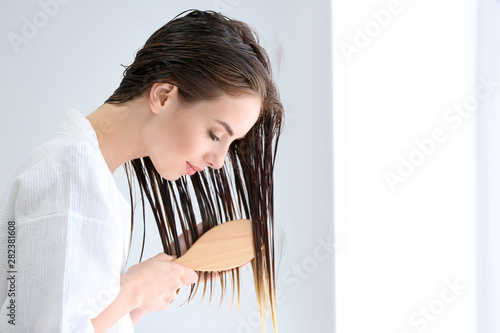 Beautiful young woman brush...